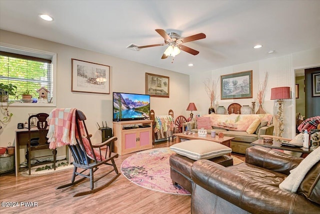 living room with ceiling fan and light wood-type flooring