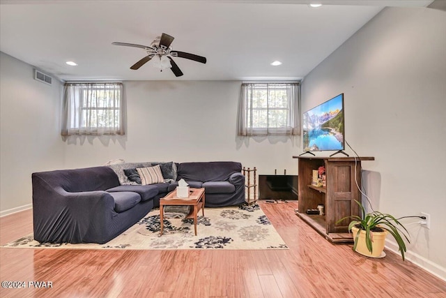 living room featuring hardwood / wood-style flooring and ceiling fan