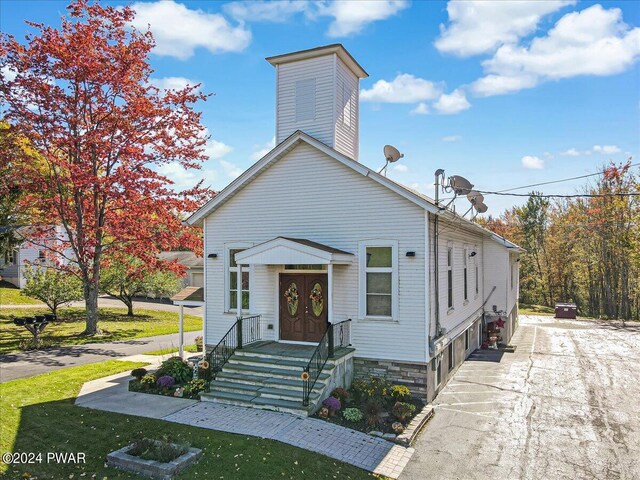 bungalow-style house with a garage and a front yard