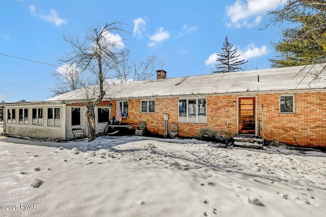 view of snow covered back of property