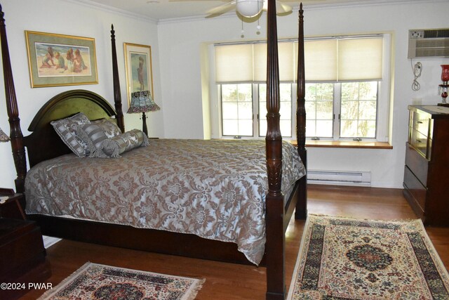 bedroom featuring ceiling fan, a wall mounted air conditioner, baseboard heating, dark hardwood / wood-style floors, and ornamental molding