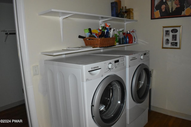 laundry room with dark hardwood / wood-style floors and washing machine and dryer