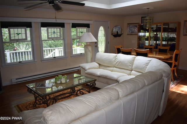 living room featuring ceiling fan, dark hardwood / wood-style flooring, ornamental molding, and a baseboard heating unit