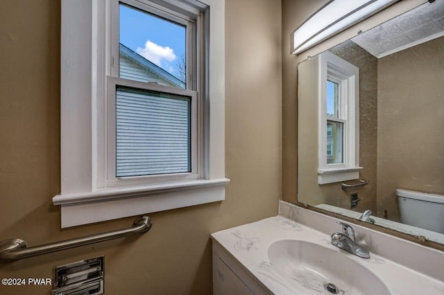 bathroom featuring vanity and toilet