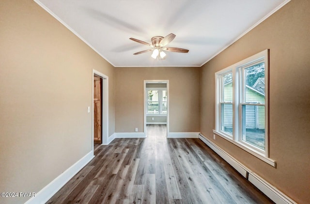 spare room with hardwood / wood-style floors, ceiling fan, ornamental molding, and a baseboard heating unit