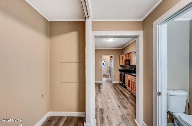 hallway with hardwood / wood-style floors and ornamental molding