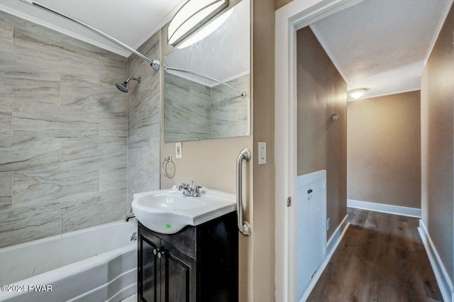 bathroom featuring vanity, tiled shower / bath combo, and hardwood / wood-style flooring