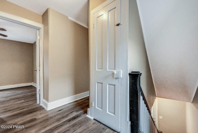 stairs featuring hardwood / wood-style flooring and vaulted ceiling