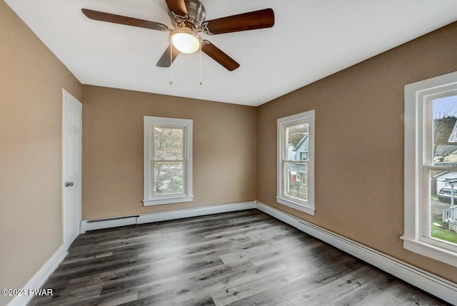 empty room with ceiling fan, dark hardwood / wood-style floors, and a baseboard radiator