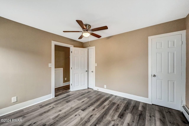 spare room featuring ceiling fan, hardwood / wood-style floors, and a baseboard radiator