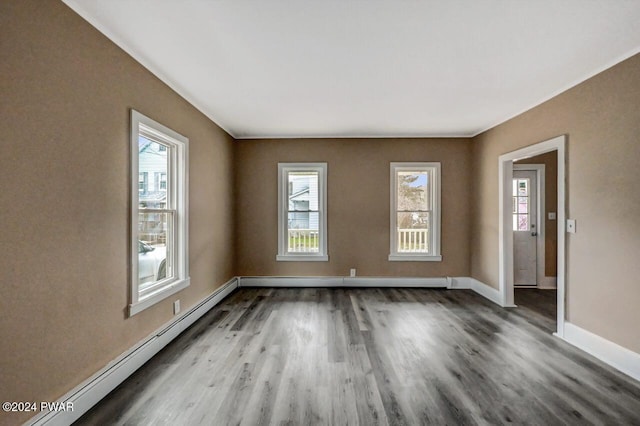 unfurnished room with wood-type flooring and a baseboard radiator