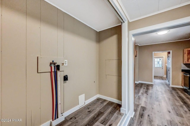 clothes washing area with washer hookup, wood-type flooring, and ornamental molding