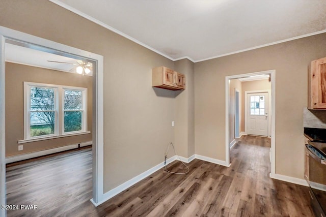 interior space with hardwood / wood-style floors, crown molding, ceiling fan, and a baseboard heating unit