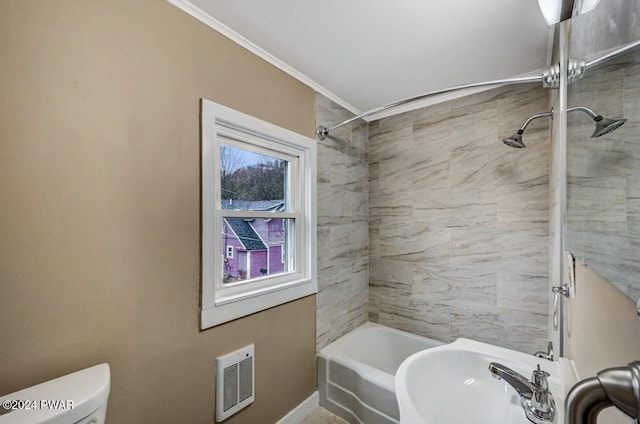 full bathroom with tiled shower / bath combo, toilet, and sink