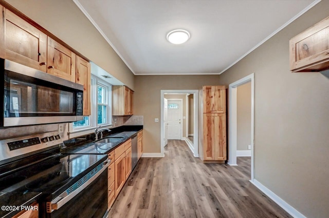 kitchen with sink, light hardwood / wood-style flooring, ornamental molding, light brown cabinetry, and stainless steel appliances