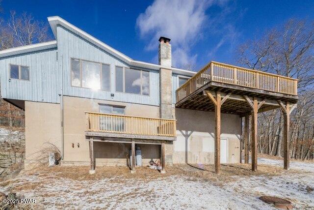 snow covered property featuring a deck