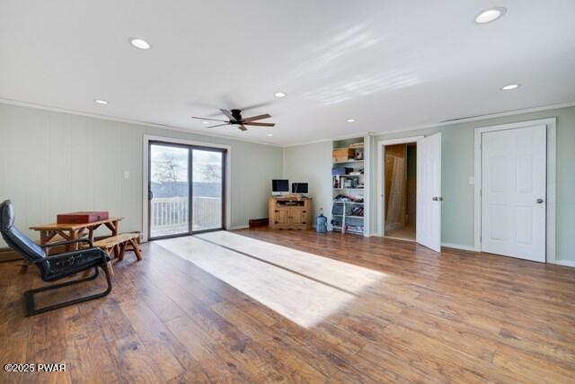 sitting room featuring ceiling fan, ornamental molding, and hardwood / wood-style flooring