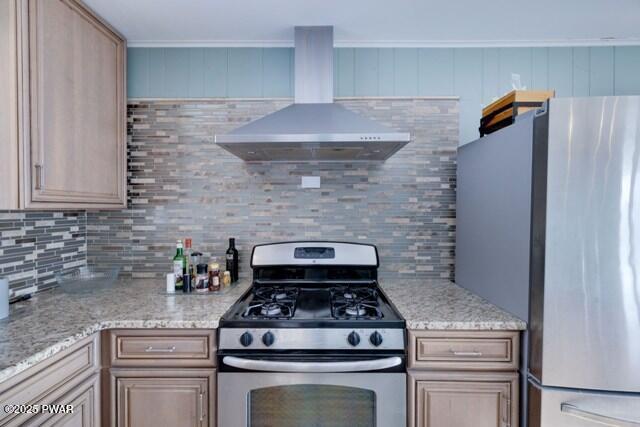 kitchen featuring backsplash, light brown cabinets, wall chimney range hood, and stainless steel appliances