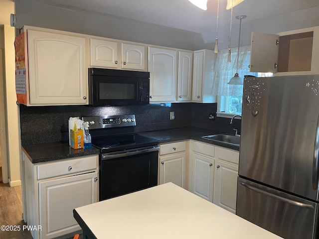110 Gold Key Rd, Milford, PA 18337 - kitchen featuring black appliances, white cabinets, tasteful backsplash, dark countertops, and wood finished floors