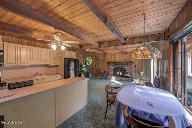 77 Brookfield Rd, Lake Ariel, PA 18436 - dining space with dark colored carpet, wooden walls, a wood ceiling with exposed beams, a fireplace, and ceiling fan