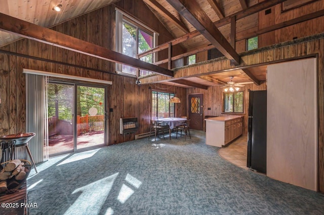 77 Brookfield Rd, Lake Ariel, PA 18436 - living area featuring wood walls, high vaulted ceiling, plenty of natural light, a ceiling fan, and light carpet