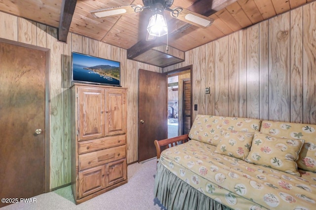 77 Brookfield Rd, Lake Ariel, PA 18436 - bedroom with a wood ceiling with exposed beams, wood walls, light colored carpet, and ceiling fan