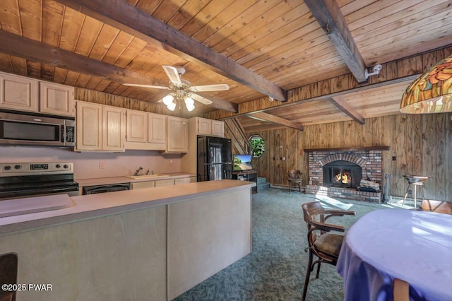 77 Brookfield Rd, Lake Ariel, PA 18436 - kitchen with electric range oven, stainless steel microwave, carpet floors, wood walls, and open floor plan