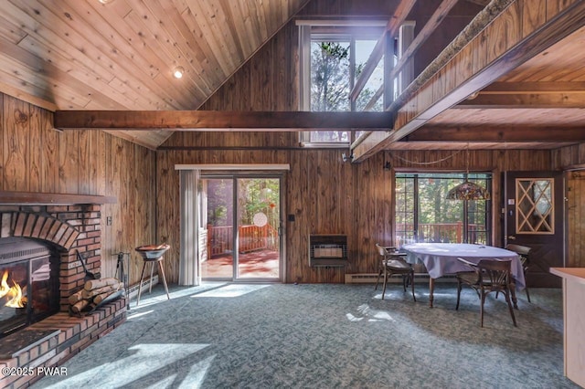 77 Brookfield Rd, Lake Ariel, PA 18436 - carpeted living area featuring wooden walls, heating unit, a wood ceiling with exposed beams, a brick fireplace, and high vaulted ceiling