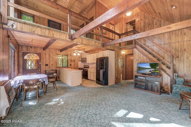 77 Brookfield Rd, Lake Ariel, PA 18436 - kitchen with freestanding refrigerator, wooden walls, electric range, a wooden ceiling with exposed beams, and light carpet