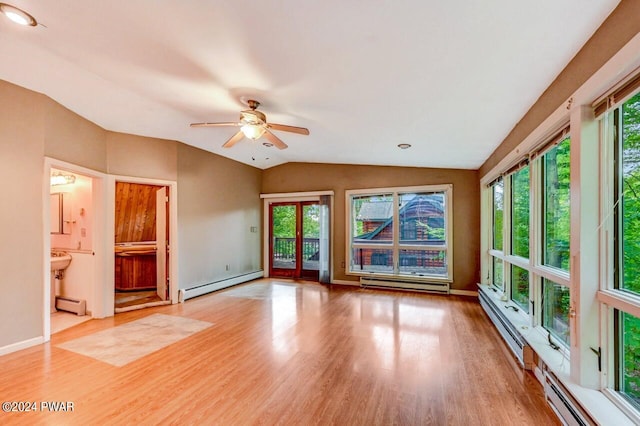 interior space featuring ceiling fan, lofted ceiling, and a baseboard heating unit