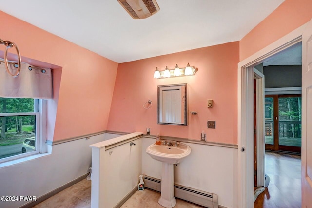 bathroom featuring tile patterned flooring, sink, and a baseboard radiator