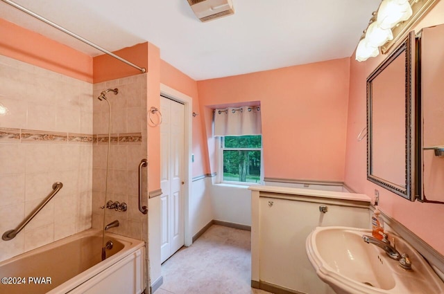 bathroom with tiled shower / bath and sink