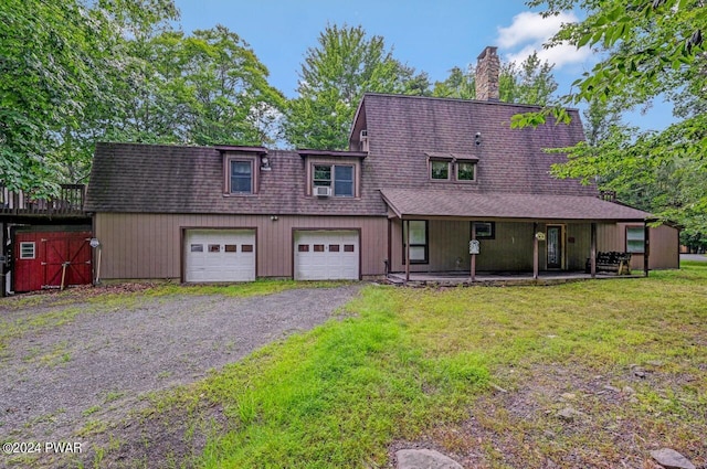 view of front of property with a front yard and a garage