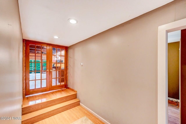 doorway with light wood-type flooring and french doors