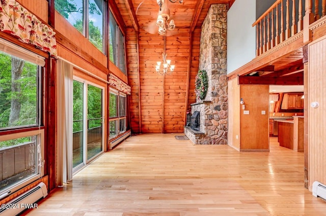 hall with high vaulted ceiling, a chandelier, light wood-type flooring, and a baseboard heating unit