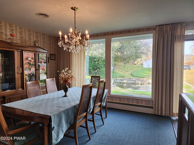 carpeted dining room with an inviting chandelier