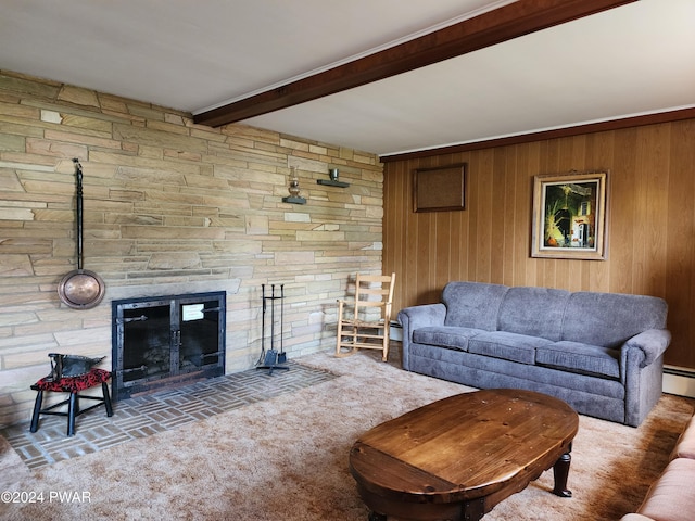 living room featuring beam ceiling, a stone fireplace, wooden walls, and carpet