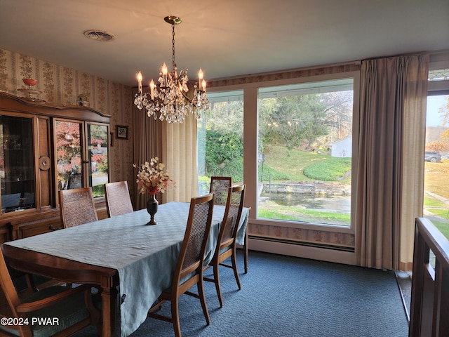 dining area featuring a wealth of natural light, dark carpet, a baseboard heating unit, and an inviting chandelier