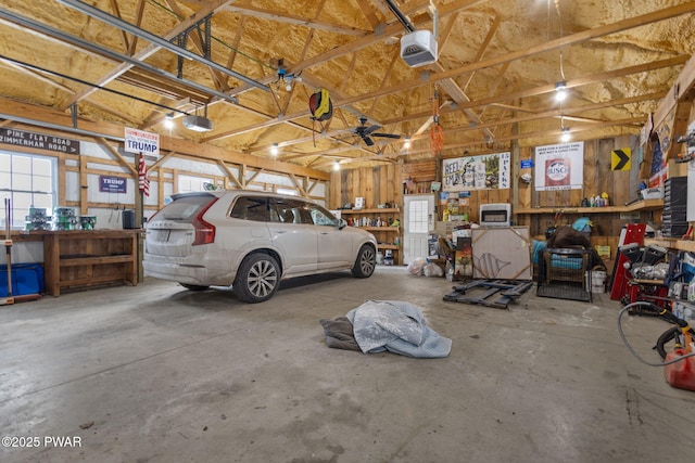 garage with a garage door opener and a workshop area