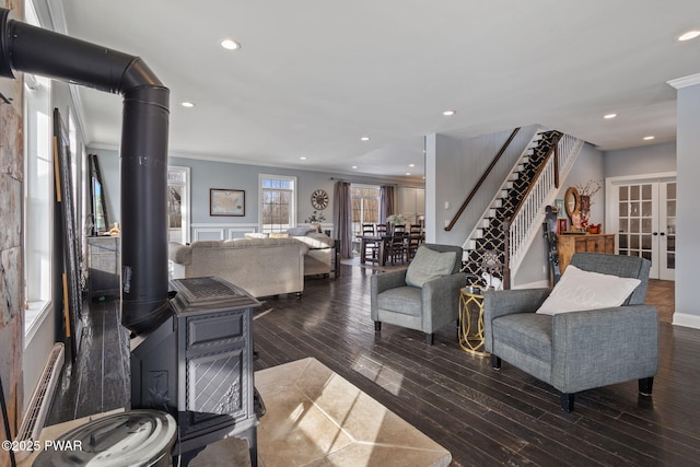 living room featuring dark wood-type flooring, ornamental molding, and french doors