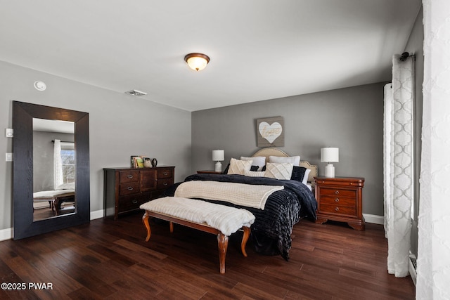 bedroom with dark wood-type flooring