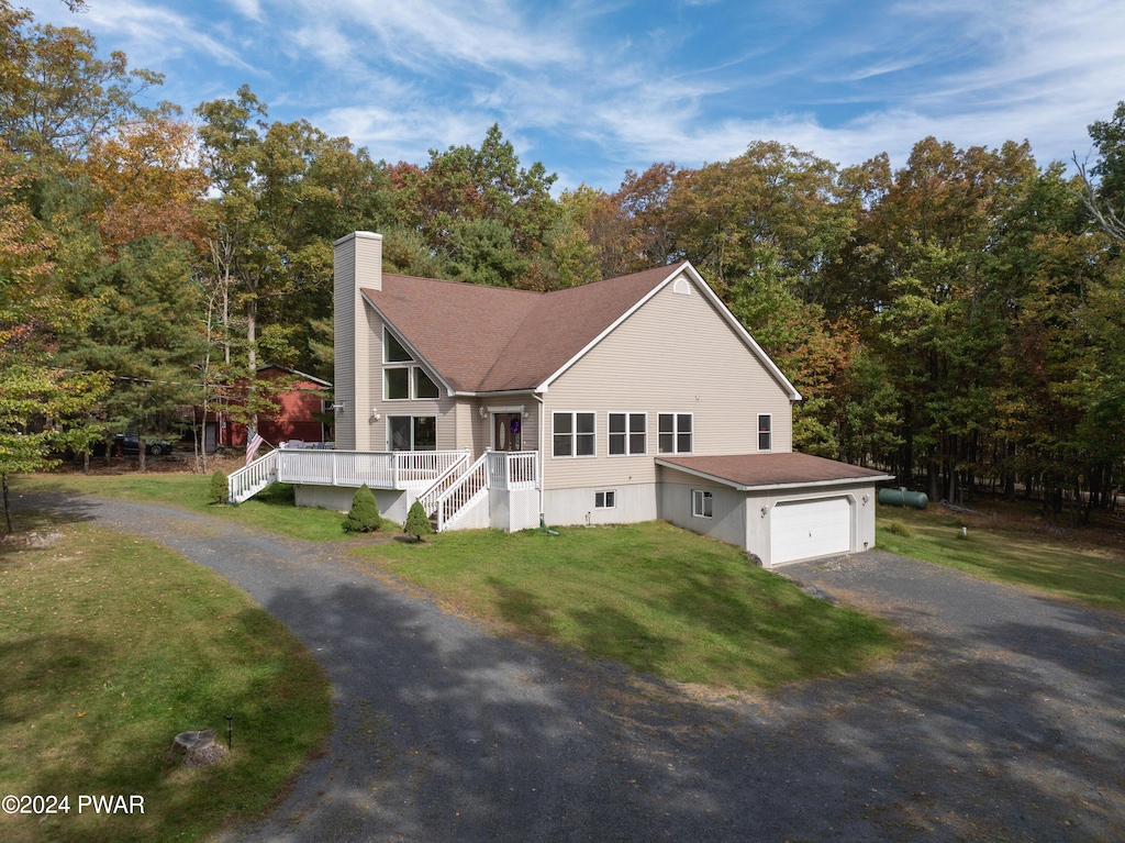 view of front of house featuring a garage and a front lawn