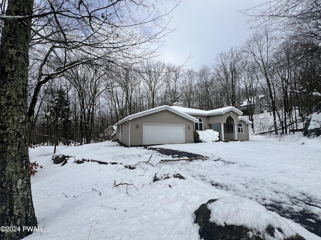 view of snowy exterior with a garage