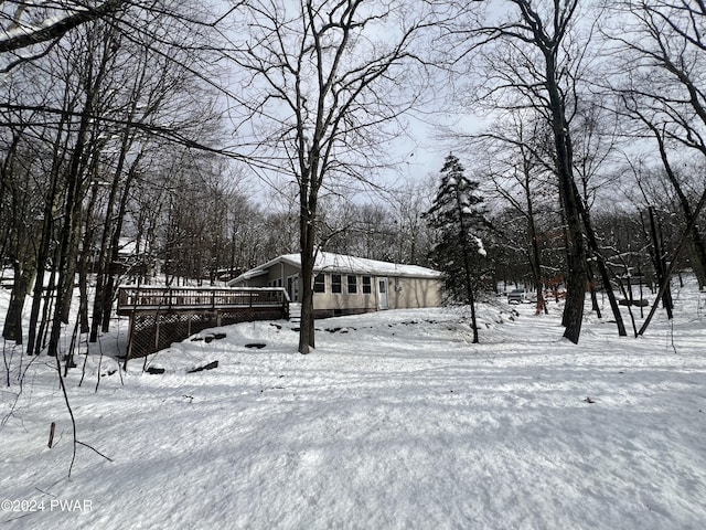 snowy yard featuring a deck