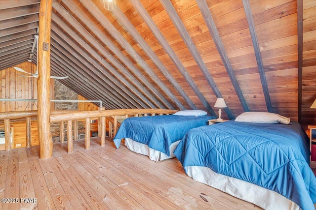 unfurnished bedroom featuring wooden walls, wooden ceiling, vaulted ceiling with beams, and wood-type flooring