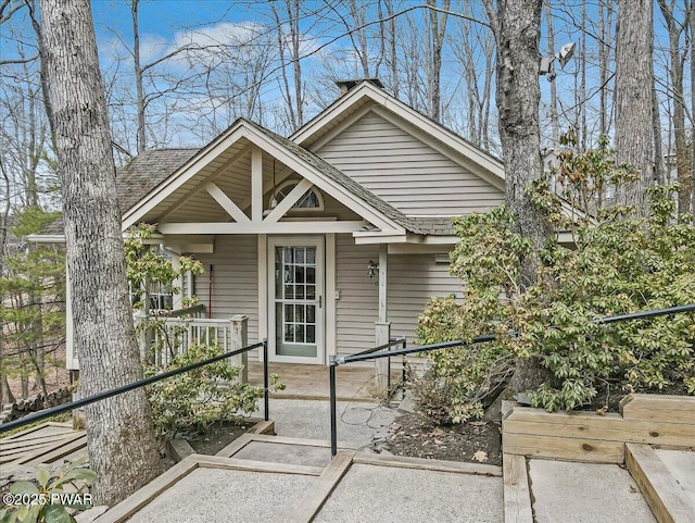 view of front of home featuring roof with shingles