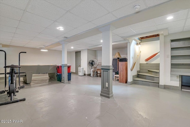 finished basement with stairway, recessed lighting, a paneled ceiling, and baseboards