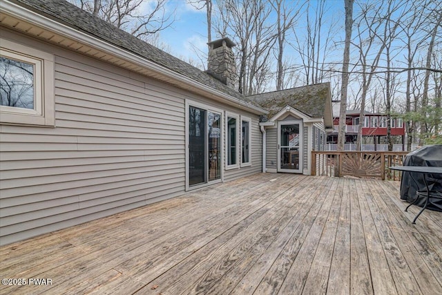 wooden deck featuring a grill