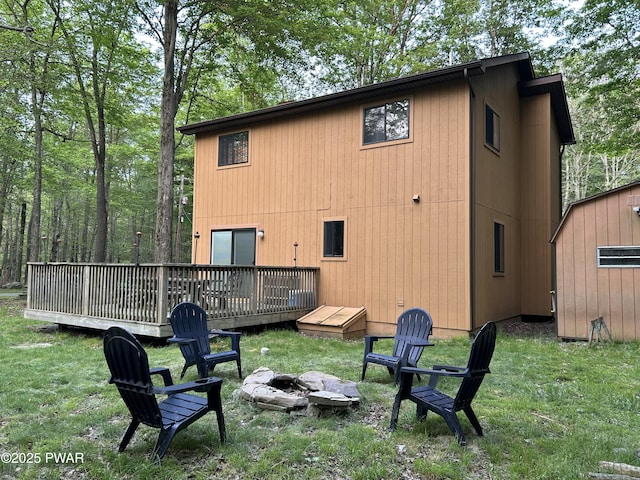 1024 Pitt Rd, Newfoundland, PA 18445 - rear view of property with a fire pit, a deck, a yard, and a storage unit