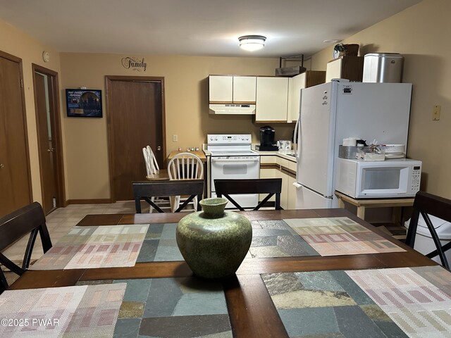 1024 Pitt Rd, Newfoundland, PA 18445 - kitchen with white appliances, under cabinet range hood, white cabinets, and light countertops